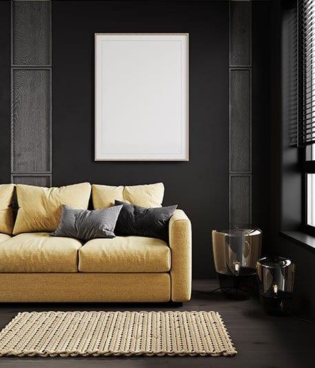 Dark-panelled living room with a mustard sofa and woven rug