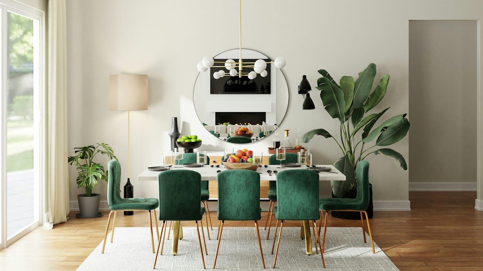 Dining room with emerald green chairs, round mirror and brass pendant